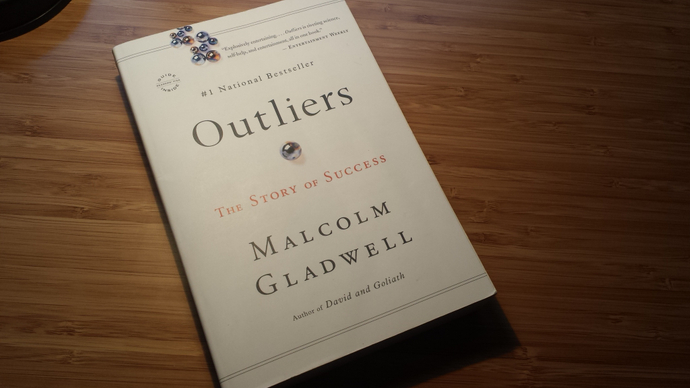 A photograph of the book Outliers by Malcolm Gladwell