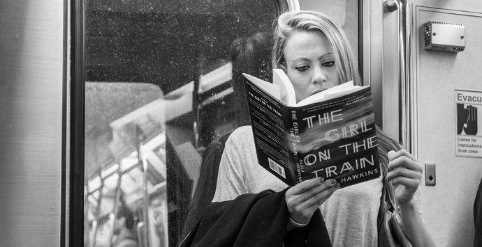 A woman reading the girl on the train in a train.